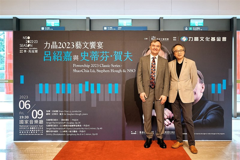 National Symphony Orchestra Conductor Emeritus Lü Shao-chia (right) and British pianist Stephen Hough pose for press photos at Wednesday