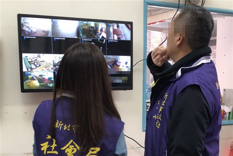 Two New Taipei City Social Affairs Department officials check surveillance video in this illustration photo taken on Jan. 9, 2019 and released later by the city government later that day.