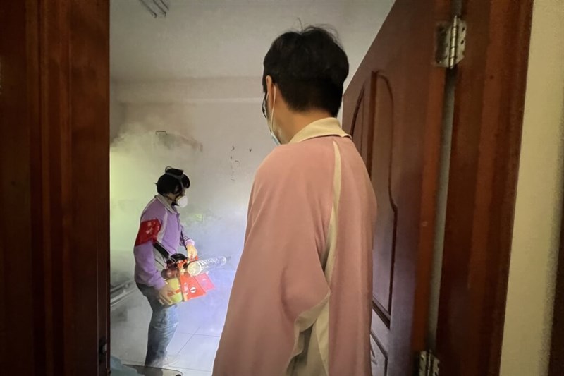 A santitation worker disinfects a premises in Tainan