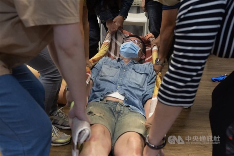 Forward Volunteers practice relocating a wounded individual as a part of a first-aid class. CNA file photo