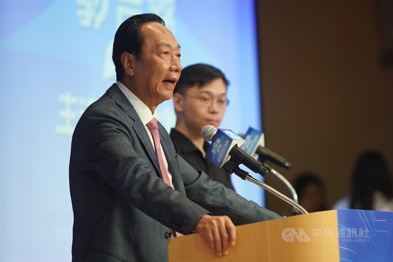 Business tycoon Terry Gou (front) speaks at a press conference, accompanied by his campaign spokesperson Huang Shih-hsiu (back), in Taipei on Monday. CNA photo Aug. 28, 2023