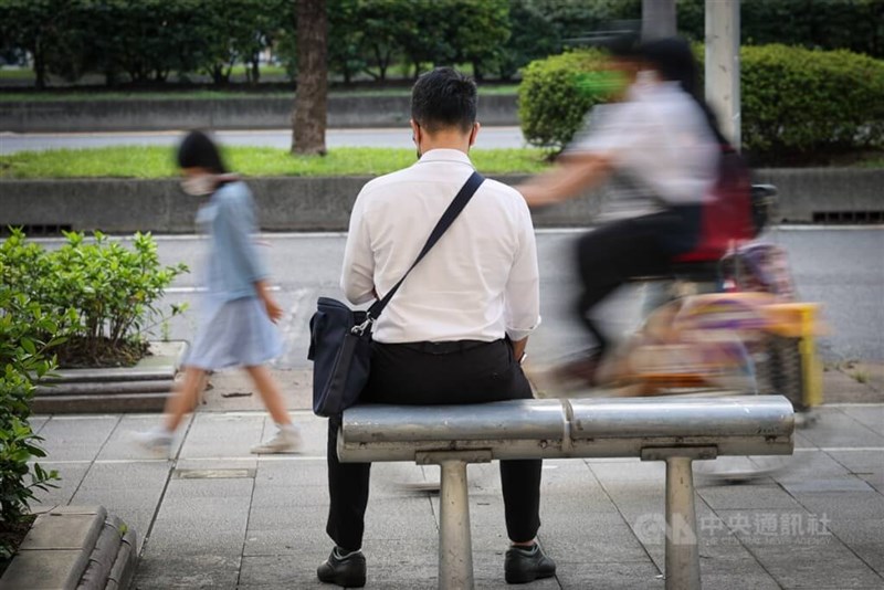 A white-collar worker sits on a metal bench in this undated photo in Taipei. CNA file photo