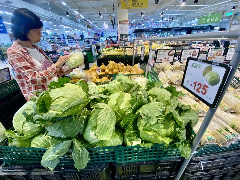 A shopper on Wednesday checks a cabage at a market in Kaohsiung, which is priced at NT$125 (US$3.9) each. CNA photo Sept. 6, 2023