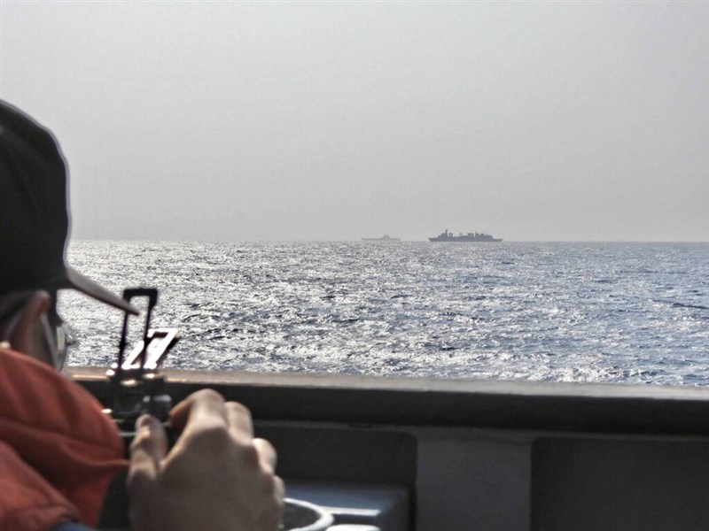 A serviceman on a naval vessel observes the Chinese aircraft carrier Shandong (far back) after the vessel passes through the Bashi Channel on April 5. File photo courtesy of Ministry of National Defense for illustrative purpose only