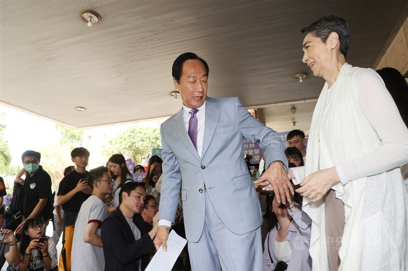 Foxconn founder Terry Gou and his running mate, actress Tammy Lai, register at the Central Election Commission to begin a signature drive to qualify for next year