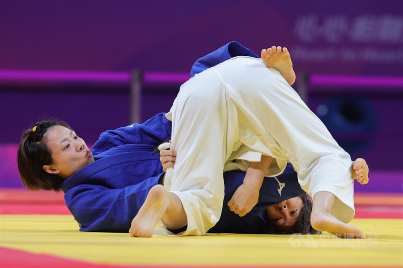 Lien Chen-ling (in blue) competes against Momo Tamaoki from Japan in the women