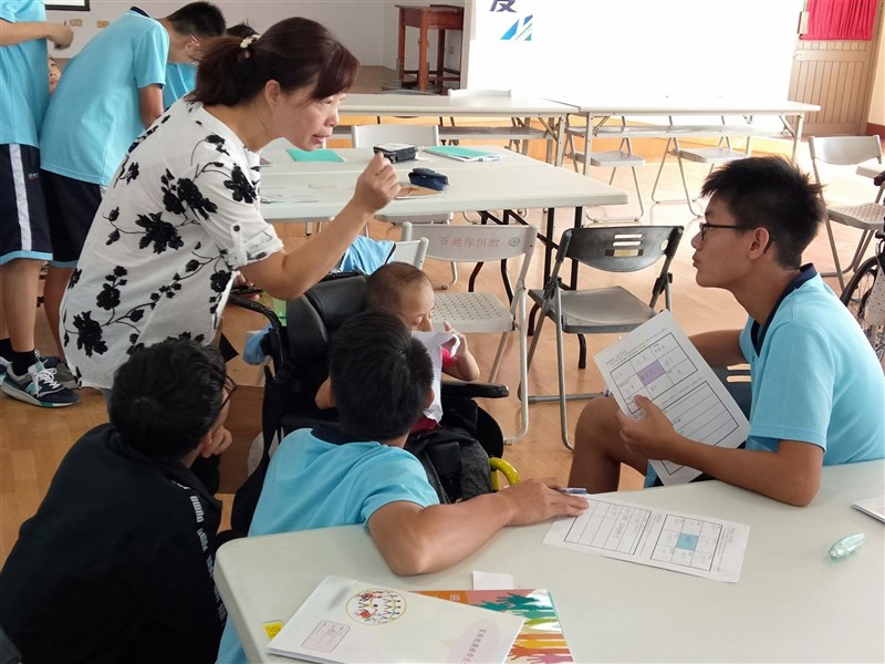 A teacher interacts with students and some of those with specials needs in a school in Changhua County in this undated photo. File photo courtesy of Ministry of Education