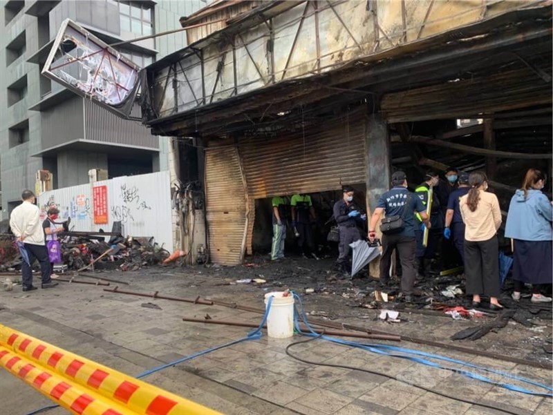 Investigators examine the tire shop struck by a fire in Hsinchu City in June 2022. CNA file photo