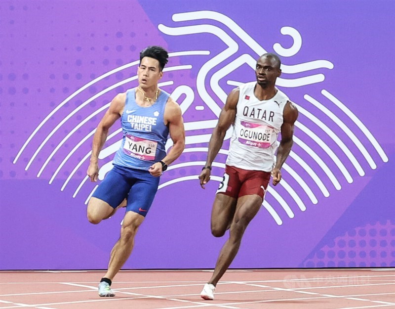 Taiwanese sprinter Yang Chun-han (left) runs side by side with Nigerian-born Qatari runner Femi Ogunode in the men