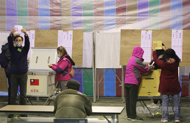 Polling station workers count the votes in the four referendums on Dec. 10, 2021. CNA file photo