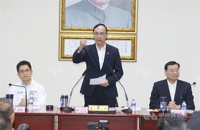 KMT Chairman Eric Chu (center) talks about the party