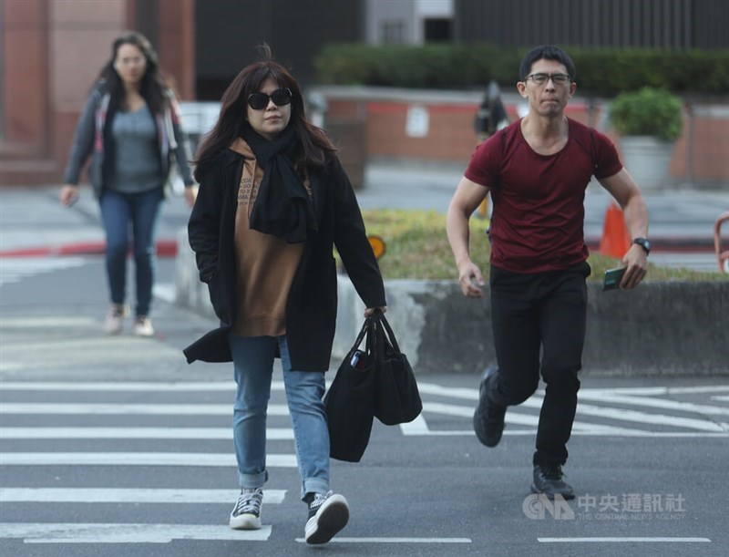 Pedestrians cross a street in Taipei