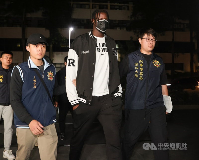 Former Dinos player Senegalese Cheikh Ahmadou Bamba Sarr (front center) is taken to the Shilin District Prosecutors Office on Nov. 17, 2023. CNA file photo
