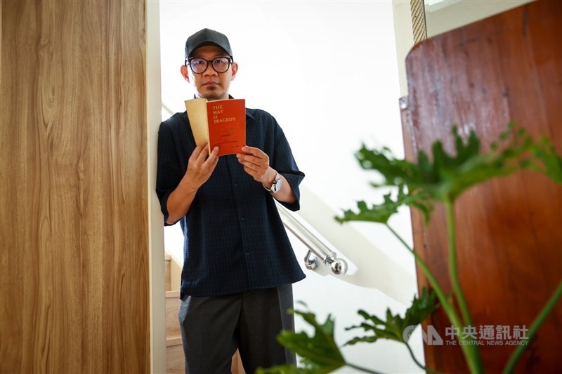 Malaysian director Chong Keat Aun holds a book about the May 13 incident in this recent photo. CNA file photo