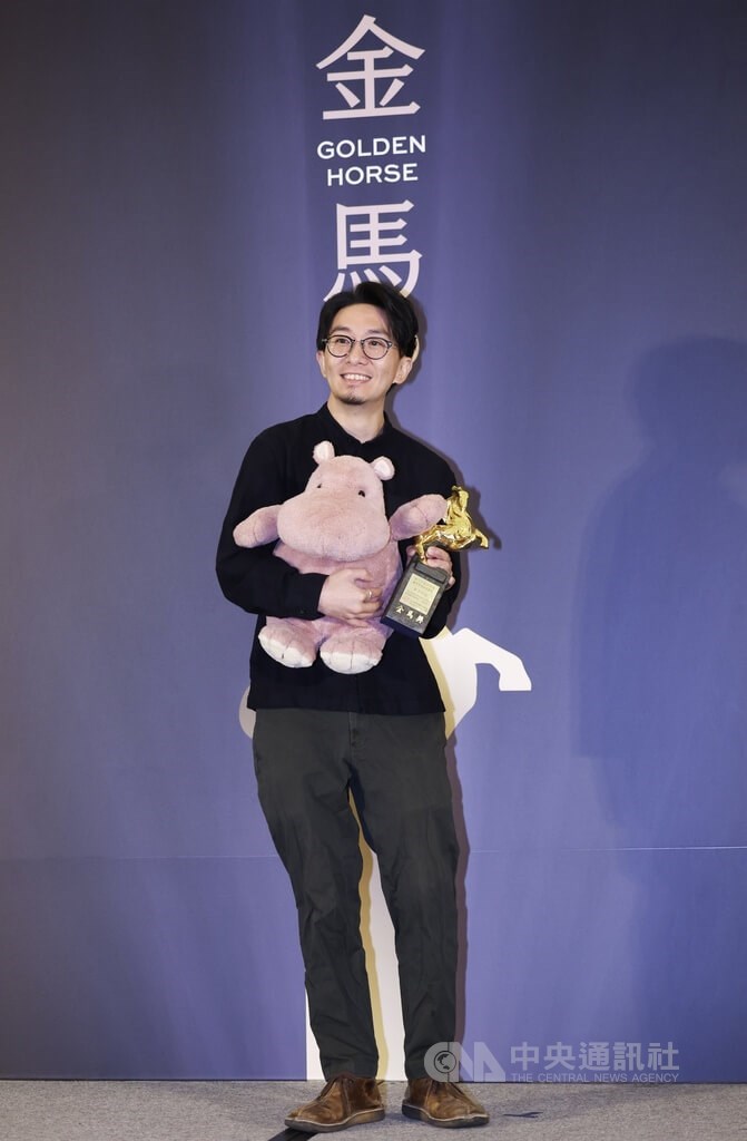 Director Nick Cheuk displays the Audience Choice Award trophy while holding a hippo doll at a Golden Horse Film Festival ceremony Friday. CNA photo Nov. 24, 2023