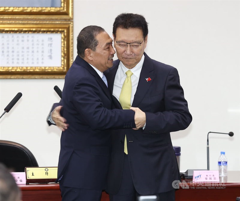Kuomintang (KMT) presidential nominee Hou Yu-ih (left) hugs and shakes hands with his running mate Broadcasting Corporation of China Chairman Jaw Shau-kong at the KMT headquarters during a Central Standing Committee meeting Friday. CNA photo Nov. 24, 2023