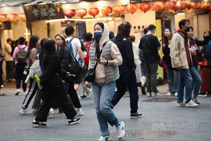 People are seen bundled up amid chilly weather in a Taipei shopping district in this undated photo. CNA file photo