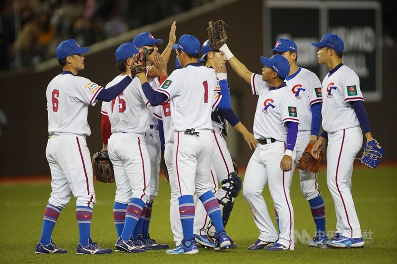 Taiwanese baseball players high-five each other after they win the Asian Baseball Championship opening game against South Korea at Taipei Dome on Sunday. CNA photo Dec. 3, 2023