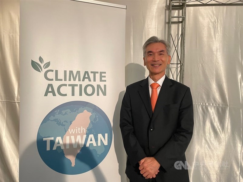 Minister of Environment Shieu Fuh-sheng stands next to a Taiwan's campaign stand at COP28 in Dubai Wednesday. CNA photo Dec. 6, 2023
