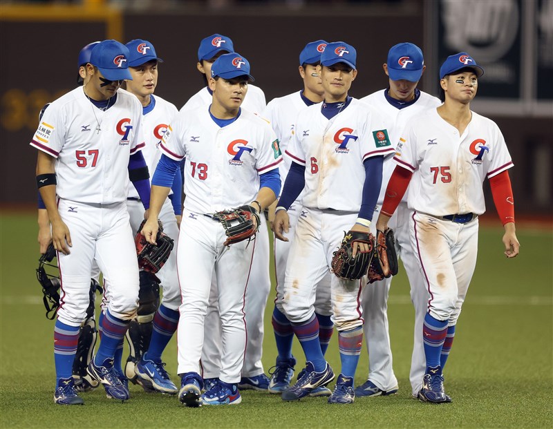 Taiwanese baseball players walk on the field together after they win the game against the Philippines at Taipei Dome on Saturday. CNA photo Dec. 9, 2023