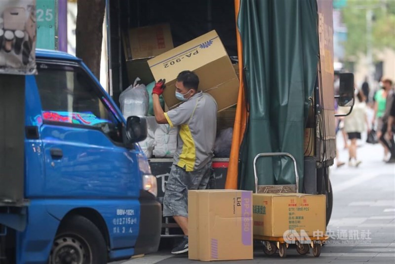 A delivery man removes a box from a truck in Taipei in this undated photo. CNA file photo