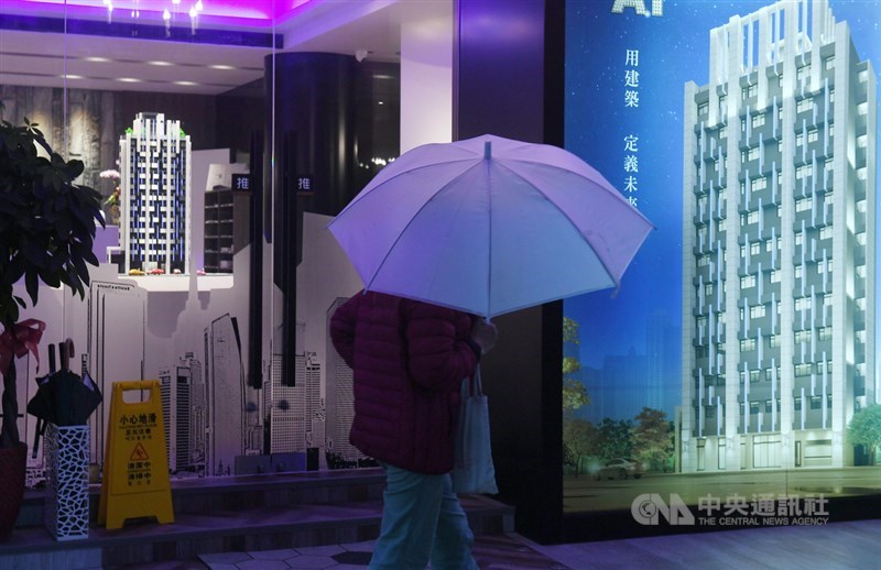 A pedestrian walks past an ad promoting a new housing project. Home buyers turned cautious amid an amended home tax law and uncertainties created by the upcoming elections in the latest consumer confidence survey released on Dec. 27, 2023. CNA file photo