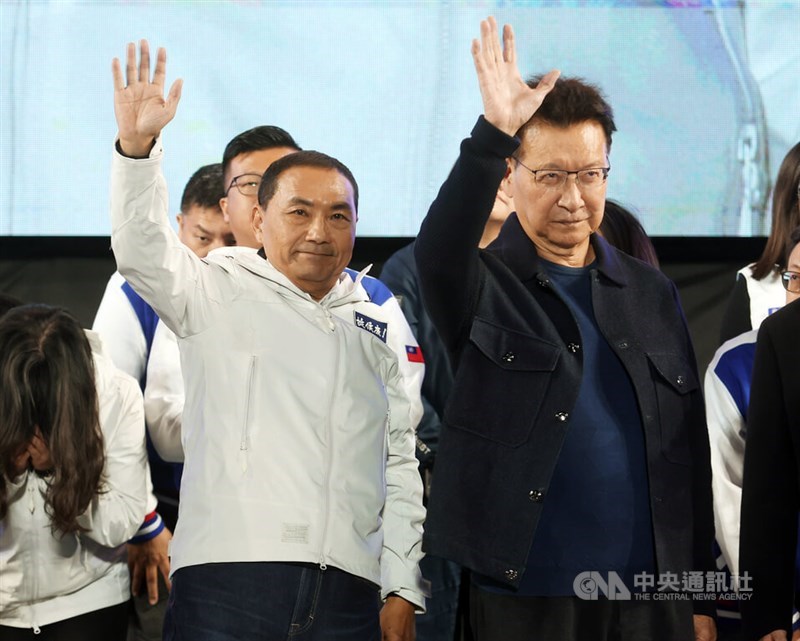 Kuomintang presidential candidate Hou Yu-ih (left) and his running mate Jaw Shau-kong wave to supporters to thank for their support in New Taipei Saturday evening. CNA photo Jan. 13, 2024