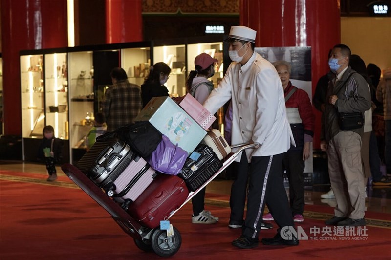 A porter transports guest luggage in the Grand Hotel in this CNA file photo