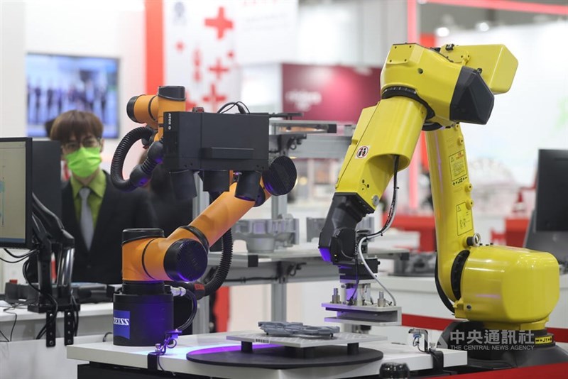 Two robotic arms are displayed as smart manufacturing devices in this CNA file