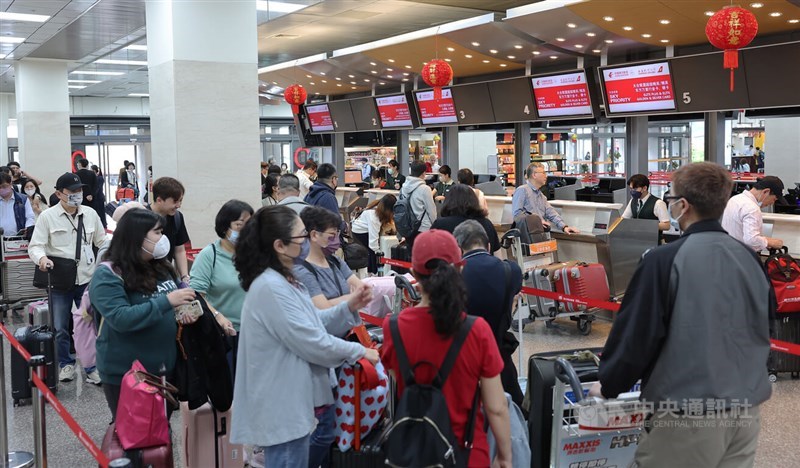 Passengers checks in at airline counters decked out in Lunar New Year decorations at the Songshan Airport in this CNA photo for illustrative purpose only