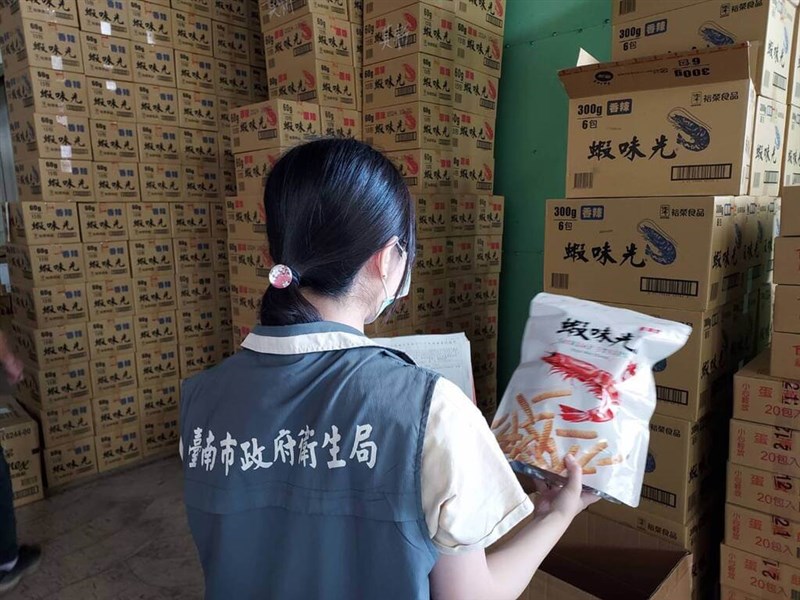 A Tainan City official checks snacks recalled at a retailer in the southen city Wednesday. Photo courtesy of Tainan City government Feb. 21, 2024