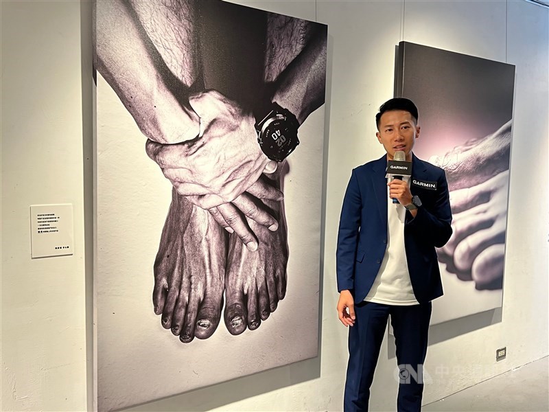 Tommy Chen speaks standing beside a picture of his feet at a photography exhibition in Taipei on June 20, 2023. CNA file photo
