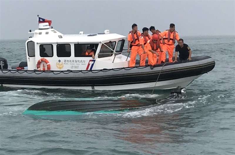 Taiwan's Coast Guard personnel carry out a rescue mission near a capsized boat, similar to the one used by the Kinmen anglers recently rescued by China in this file photo released by the authorities.