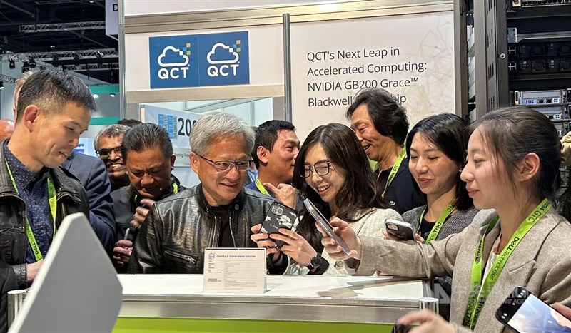 Jensen Huang (front second left), the CEO of Nvidia Corp., interacts with participants of Nvidia's GPU technology conference exhibition in San Jose, California in this recent photo. CNA photo March 24, 2024