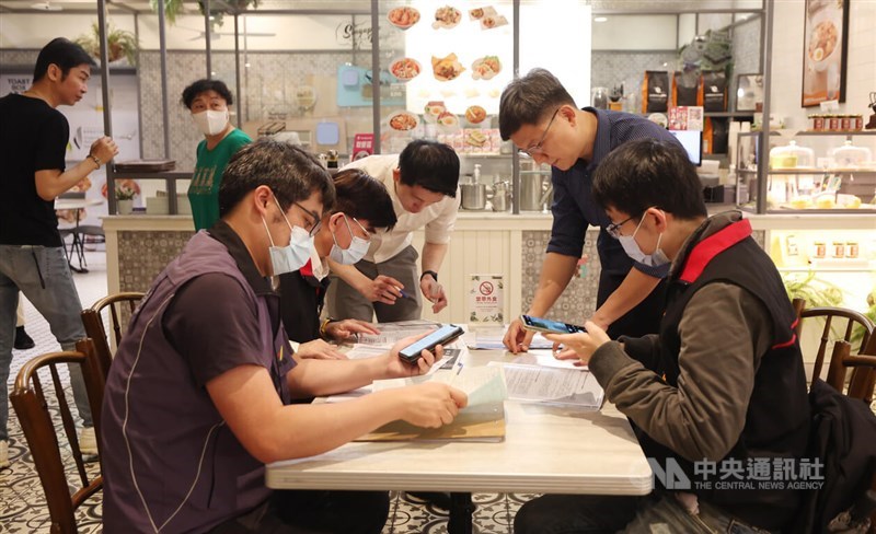 Authorities conduct a search inside the Taipei food court where Polam Kopitiam is situated. CNA photo March 29