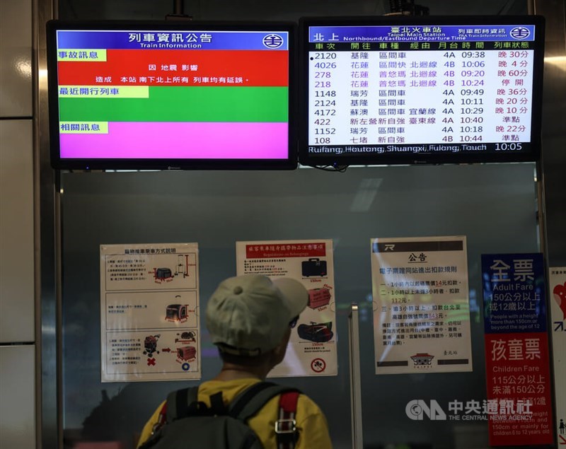 A traveler looks at screens showing information of train services at Taipei Main Station Wednesday morning. CNA photo April 3, 2024