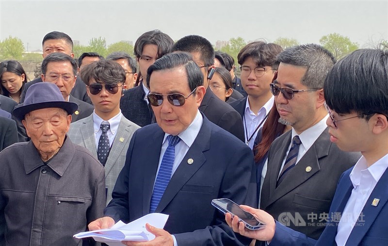 Former President Ma Ying-jeou (center, in blue tie) speaks to reporters in Beijing on Monday. CNA photo April 8, 2024