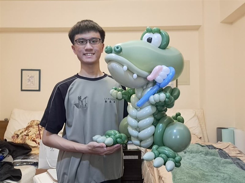 Yen Jui-chun, 11th grade winner of the Qualatex Color Quest: Cactus competition, poses with his winning entry "Alligator" in this undated photo. Photo courtesy of Yen Jui-chun May 9, 2024