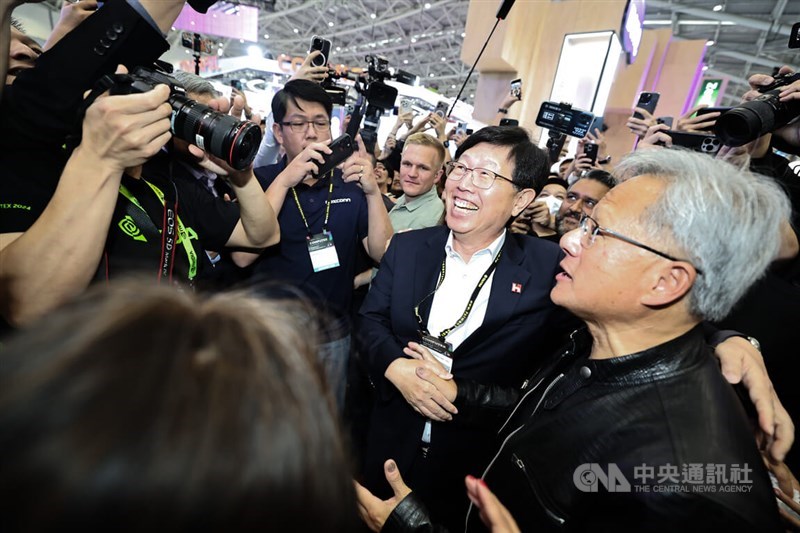 Hon Hai Chairman Young Liu (second right) shakes hands with Nvidia CEO Jensen Huang (right) when the later stopped by the booth of Hon Hai's cloud service subsidiary Ingrasys Inc. at the Computex in Taipei on Tuesday. CNA photo June 4, 2024