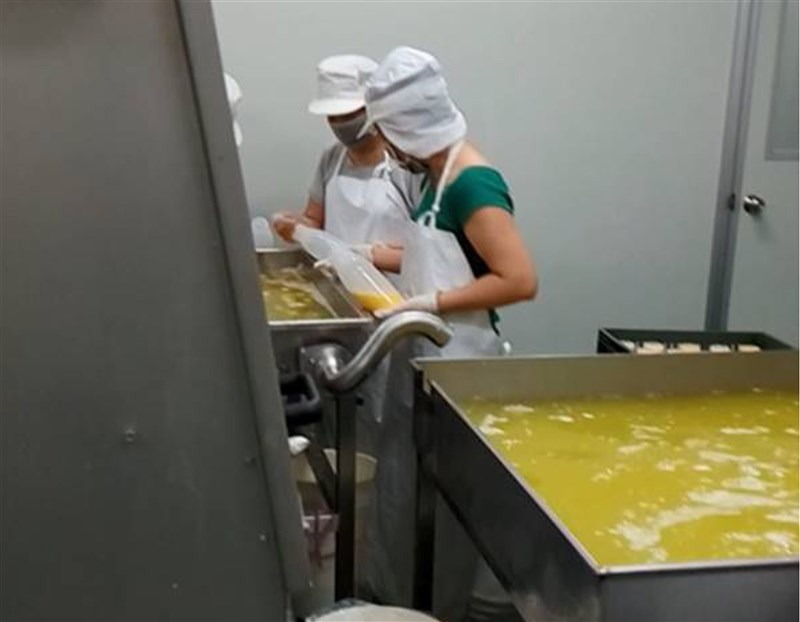 Two workers process liquid eggs at the Yuanshan Egg factory in 2018. File photo courtesy of the Taiwan Food and Drug Administration