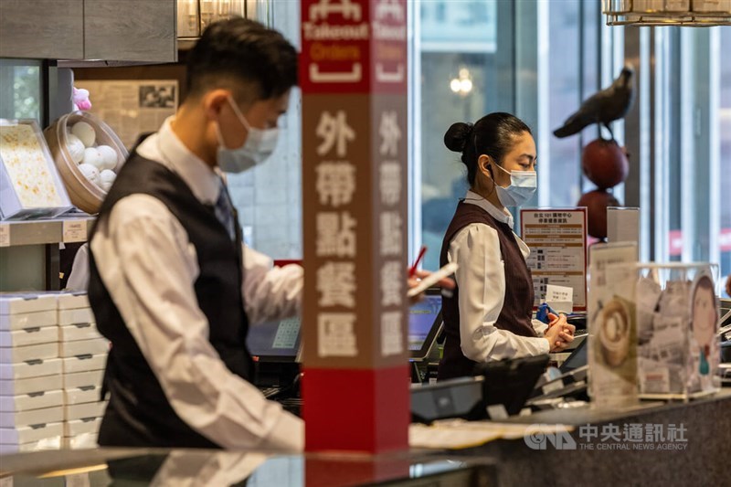 Restaurant employees man the cashier desk in this CNA file photo
