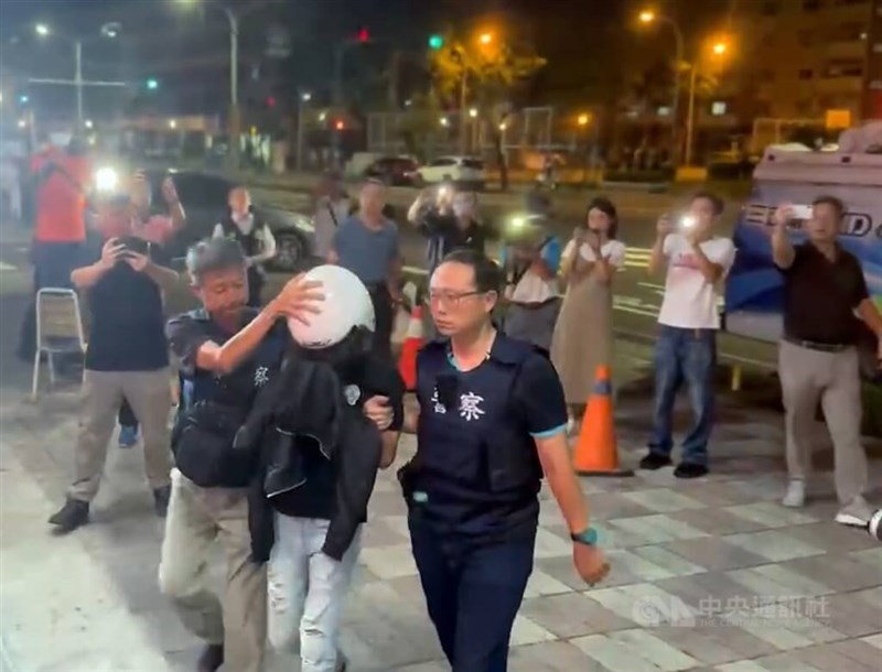 The man arrested Friday (in helmet) is brought to the Tainan City Police Department's 6th Precinct. CNA photo July 12, 2024