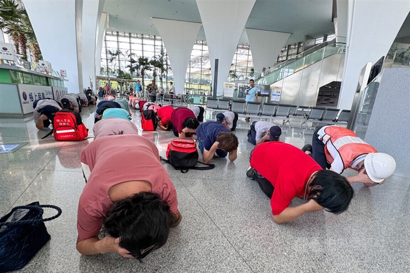 People cover their ear in a brace position at the Changhua Station of Taiwan High Speed Rail during the Wanan air raid drills on Monday. CNA photo July, 22, 2024