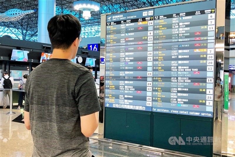 A passenger checks the flight status board at Taoyuan Airport Wednesday morning. CNA photo July 24, 2024