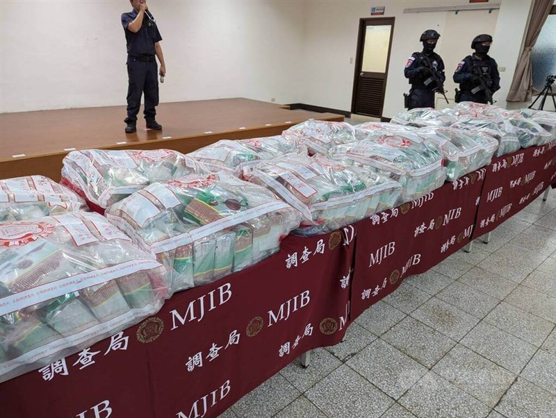 Armed police officers guard a total 525 kilograms of amphetamine and ketamine at a news conference held for the drug smuggling case in Taichung Monday. CNA photo July 29, 2024