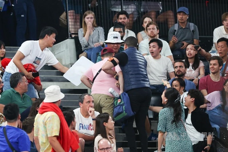 A man suspected of being Chinese (in a pink shirt) is dragged by security personnel on Friday during the games of Taiwanese shuttlers Lee Yang and Wang Chi-lin.CNA photo Aug. 2, 2024