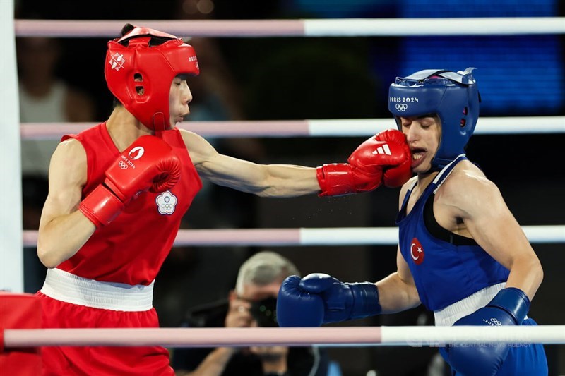 Taiwanese boxer Lin Yu-ting (in red) advanced to the gold-medal bout in the women's 57-kilogram featherweight class at the Paris Olympics on Wednesday, after defeating Turkey's Esra Yildiz Kahraman (in blue) by a unanimous decision.