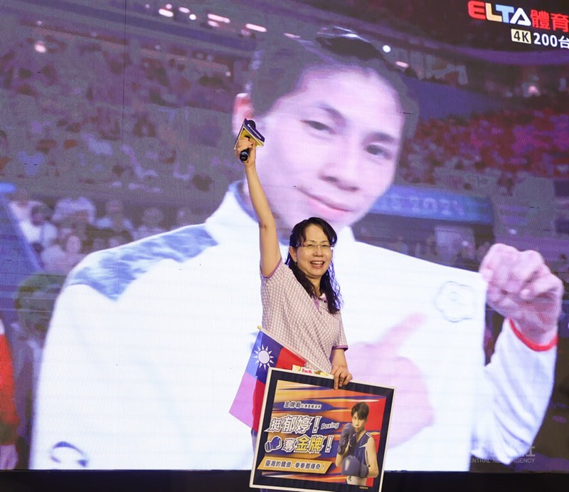 Taiwanese boxer Lin Yu-ting's mother Liao Hsiu-lan waves at participants in an event held at New Taipei City Hall early Sunday morning. CNA photo Aug. 11, 2024