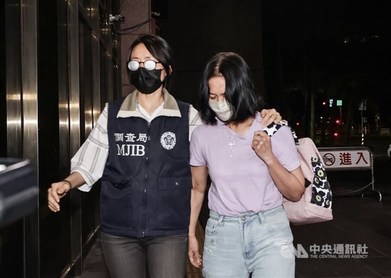 Li Wen-chuan (right), chairperson of MuKo Public Relations, is escorted by an Investigation Bureau official on Wednesday. CNA photo Aug. 14, 2024