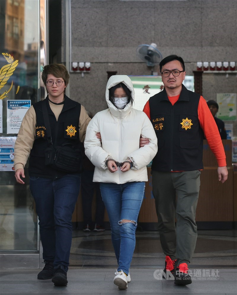 The social worker (center), identified only by her surname Chen, is taken in by police for questioning on March 12, 2024. CNA file photo